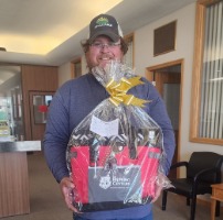 Prize winner holding gift basket.